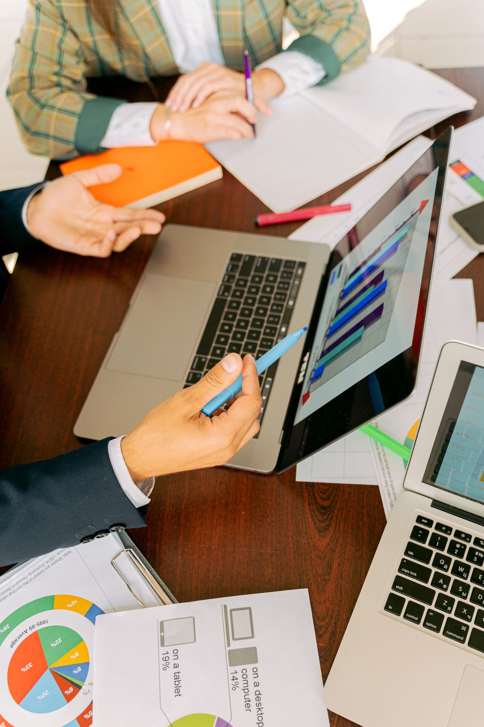 People reviewing plans and charts at a desk